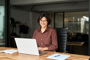 A woman looks at healthcare cost data on a computer.