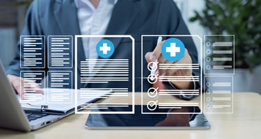  A male employee updating healthcare compliance modules on a laptop. 