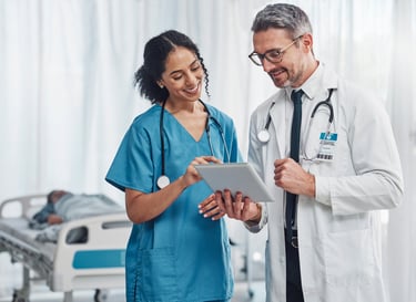 A female doctor reviews a patient's chart with a amale nurse in an emergency room. 