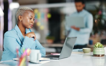 A business woman uses a laptop to review healthcare options.
