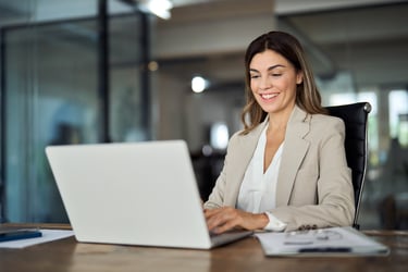 A business woman reviews the latest Rx MRF requirements on a computer.