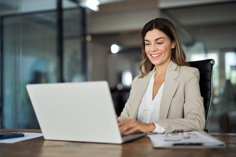 A business woman reviews the latest Rx MRF requirements on a computer.