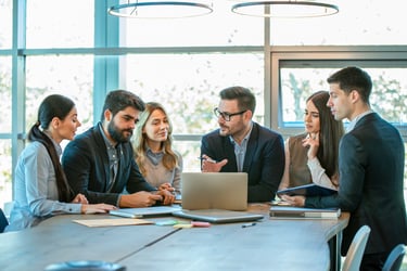 A group of employees meet in a conference room. 
