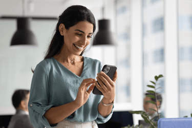 A female employee uses a healthcare navigation tool on her cellphone.