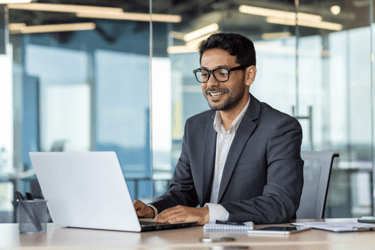 Health plan employee using a computer in an upscale office. 
