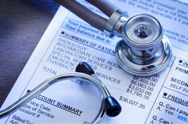 Stethoscope placed on top of a medical bill.