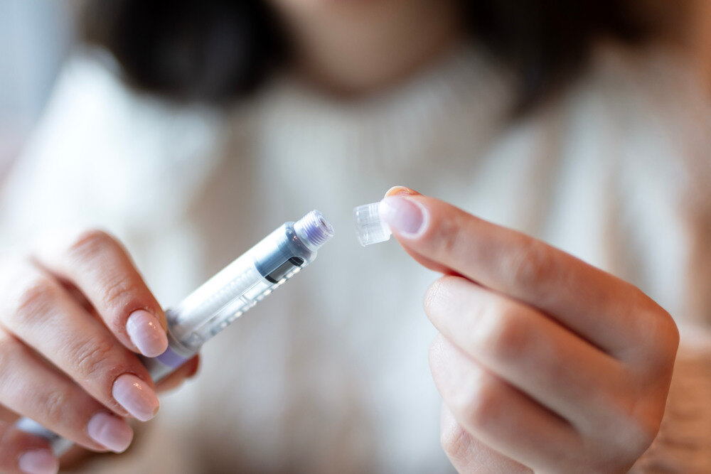 A female patient holding an injection.