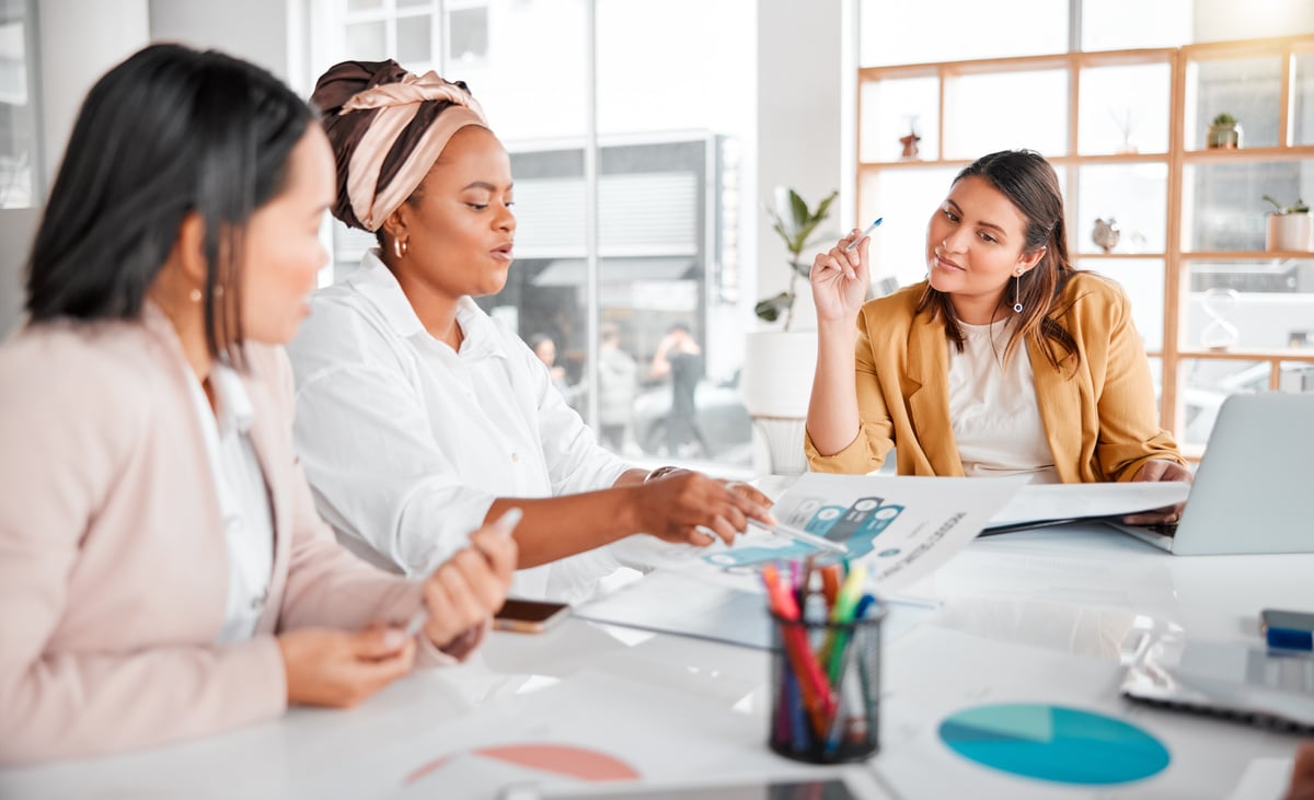 A group of business people in a meeting to discuss company growth.